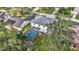 Two-story house with inground pool and screened patio, great backyard space, surrounded by lush trees at 8378 Gibralter St, Spring Hill, FL 34608