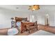 Main bedroom with hardwood floors, ceiling fan, and wood furniture at 8378 Gibralter St, Spring Hill, FL 34608