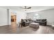 Living room features gray sofas and a view into the kitchen at 8378 Gibralter St, Spring Hill, FL 34608