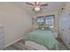 Bedroom with ceiling fan, large bed and window at 497 Spotted Slipper Pl, Ruskin, FL 33570