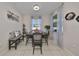 Bright dining room with a table and bench seating for six at 497 Spotted Slipper Pl, Ruskin, FL 33570