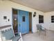 Inviting front porch with blue door and rocking chairs at 112 N Bay Hills Blvd, Safety Harbor, FL 34695