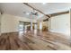 Spacious living room featuring hardwood floors and a high ceiling with exposed beams at 10520 Collar Dr, San Antonio, FL 33576