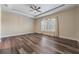 Spacious bedroom with wood-look floors and a ceiling fan at 10520 Collar Dr, San Antonio, FL 33576