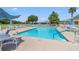 Inviting community pool with plenty of lounge chairs and umbrellas at 10520 Collar Dr, San Antonio, FL 33576