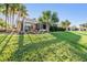 Landscaped backyard with a covered patio and lush greenery at 10520 Collar Dr, San Antonio, FL 33576