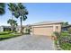 Beautiful home exterior with palm trees and a paved driveway at 10520 Collar Dr, San Antonio, FL 33576