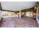 Large screened patio with brick pavers and an outdoor kitchen at 10520 Collar Dr, San Antonio, FL 33576