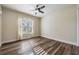 Spacious bedroom with wood-look flooring and plenty of natural light at 10520 Collar Dr, San Antonio, FL 33576