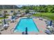Community pool with ample seating and umbrellas for shade at 10520 Collar Dr, San Antonio, FL 33576