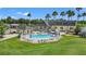 Aerial view of community pool and clubhouse with surrounding landscape at 10520 Collar Dr, San Antonio, FL 33576