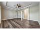 Large main bedroom with wood-look flooring and access to the bathroom at 10520 Collar Dr, San Antonio, FL 33576
