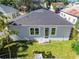 Rear view of house showing gray exterior, lawn, and roof at 2921 Sanchez St, Tampa, FL 33605