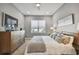 Spacious bedroom with a king-size bed, dresser, and large windows at 2921 Sanchez St, Tampa, FL 33605