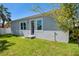 Rear exterior of house with gray siding and landscaping at 2921 Sanchez St, Tampa, FL 33605
