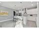 Contemporary kitchen boasting white cabinets, stainless steel appliances, and a breakfast bar at 2921 Sanchez St, Tampa, FL 33605