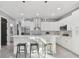 Modern white kitchen with stainless steel appliances and a breakfast bar at 2921 Sanchez St, Tampa, FL 33605