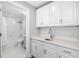 White cabinets and counters alongside an alcove shower/bathtub in this full bathroom at 5902 Yeats Manor Dr, Tampa, FL 33616