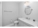 Simple bathroom design with a round mirror, a single vanity sink and a shower at 5902 Yeats Manor Dr, Tampa, FL 33616