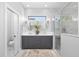 Bright bathroom boasts dual sinks, modern fixtures, and a luxurious glass-enclosed shower at 5902 Yeats Manor Dr, Tampa, FL 33616
