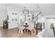Elegant dining area with hardwood floors, modern lighting, and neutral decor, creating a comfortable space at 5902 Yeats Manor Dr, Tampa, FL 33616
