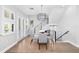 Bright dining area features hardwood floors, modern light fixture, and staircase access at 5902 Yeats Manor Dr, Tampa, FL 33616