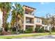 A beautiful three-story townhome featuring balconies and landscaped surroundings, perfect for comfortable living at 5902 Yeats Manor Dr, Tampa, FL 33616