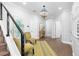 Elegant foyer with hardwood floors, staircase, stylish lighting, and neutral decor, creating a welcoming entrance at 5902 Yeats Manor Dr, Tampa, FL 33616