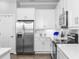 Contemporary kitchen equipped with stainless steel appliances, white cabinets, and sleek countertops for cooking enjoyment at 5902 Yeats Manor Dr, Tampa, FL 33616