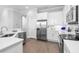 Updated kitchen features stainless appliances, white cabinetry, tiled backsplash and hardwood floors for cooking enjoyment at 5902 Yeats Manor Dr, Tampa, FL 33616
