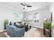 Living room with hardwood floors, a ceiling fan, and comfortable seating arrangements at 5902 Yeats Manor Dr, Tampa, FL 33616