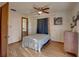 Simple bedroom with wood flooring, ceiling fan and access to the bathroom at 1106 Oxbow Rd, Wimauma, FL 33598