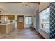 Bright kitchen features wood cabinets and flooring, and a view to the backyard at 1106 Oxbow Rd, Wimauma, FL 33598