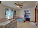 Bedroom with twin beds, ceiling fan and beach-themed window decor at 1106 Oxbow Rd, Wimauma, FL 33598