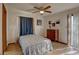 Cozy bedroom with wood flooring, ceiling fan, and a dresser at 1106 Oxbow Rd, Wimauma, FL 33598