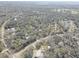 Aerial view showing homes and roads in a wooded community setting at 1106 Oxbow Rd, Wimauma, FL 33598