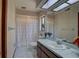 Clean bathroom with shower/tub combo, vanity, and tiled floors at 1106 Oxbow Rd, Wimauma, FL 33598