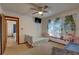 Bedroom with twin beds, ceiling fan and access to another bedroom at 1106 Oxbow Rd, Wimauma, FL 33598