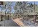 Wooden deck overlooking a wooded area, offering peaceful views at 1106 Oxbow Rd, Wimauma, FL 33598