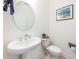 Clean and modern bathroom with pedestal sink and toilet at 2444 Foggy Creek Cir, Clearwater, FL 33764