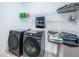 Convenient laundry room with washer, dryer, and ample shelving at 2444 Foggy Creek Cir, Clearwater, FL 33764