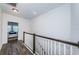 Upstairs hallway with hardwood floors and view of bedroom at 2444 Foggy Creek Cir, Clearwater, FL 33764