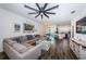Spacious living room with L-shaped sectional sofa and kitchen views at 2444 Foggy Creek Cir, Clearwater, FL 33764
