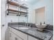 Elegant bathroom with granite countertops and industrial-style shelving at 2444 Foggy Creek Cir, Clearwater, FL 33764