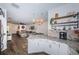 Kitchen with granite countertops, white cabinets, and view into living room at 2444 Foggy Creek Cir, Clearwater, FL 33764