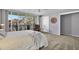 Bedroom with queen bed, balcony access, and chair at 1012 Pearce Dr # 209, Clearwater, FL 33764
