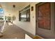Residential hallway leading to condo unit, featuring tiled floors and neutral walls at 1012 Pearce Dr # 209, Clearwater, FL 33764