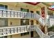 Exterior stairwell with white railings and access to multiple levels of the building at 1012 Pearce Dr # 209, Clearwater, FL 33764