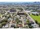 Aerial view of neighborhood with houses, park, and downtown skyline in background at 2921 Sanchez St, Tampa, FL 33605