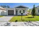 Modern house exterior with gray garage door and gray accents at 2921 Sanchez St, Tampa, FL 33605